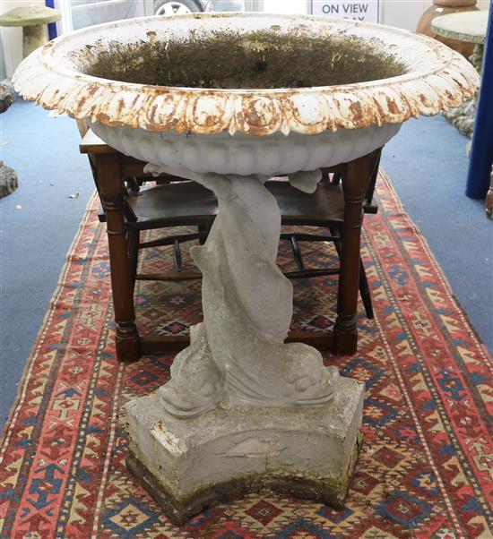 A Victorian cast iron garden urn on dolphin support W.100cm